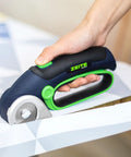 Zeite 4 V Cordless Electric Scissors Cardboard Cutter cutting fabric with easy grip handle and rotating blade.