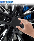 Slick Black Car Wheel Rim Center Caps 4 Pack Heavy Duty Abs Snap In Hub Covers Universal Fit For Cars Trucks And Jeeps 2.13 Inch Outer Diameter, finger touching black wheel cap on alloy wheel.