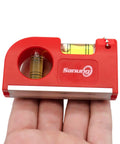 Close-up of red Two Piece Mini Magnetic Pocket Spirit Level with keychain on hand, showing magnetic base and two glass vials for leveling.