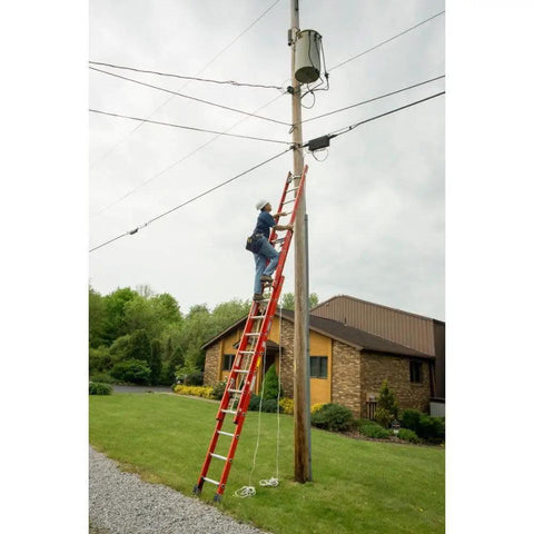 Person using ladder with Cable Hook And V Rung Assembly In Aluminum All In One Dual Function Hook And V Rung on utility pole.