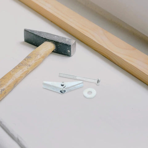 30 Pack Heavy Duty Carbon Steel Drywall Anchors With No Fuss Install Mushroom Petal Expansion Screws on workbench with hammer.