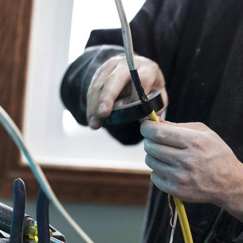 Person using Contractor Favorite Pro Grade Multicolor Electrical Tape 10 Pack Three Quarters Inch By 66 Feet Waterproof on wiring