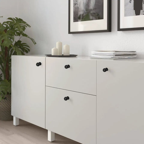 Matte Black Cabinet Knobs Four Pack with Wide Backplates on white dresser in modern living room