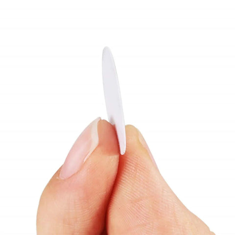 Close-up view of a single white screw hole sticker from 580 Pcs Self Adhesive Screw Hole Stickers Six Pack White Caps For 12mm 15mm And 21mm Dustproof Covers Two Sheets Each Great DIY Fix For Cabinets Furniture And More