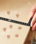 Khaki Wood Cabinet Hole Plugs 50 Pack Reusable Design Easy Replacement for DIY Projects shown next to ruler on wood surface