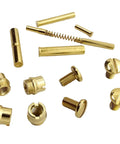 Straight Up Quality Polished Gold Plated 1911 Grip Screws Pins And Bushings Set assorted components in gold finish on white background.