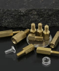 Male Female Brass Hex Standoff Kit For PCB And Motherboard Installations With M2.5 M3 M4 Spacers Nuts And Bolts Quick Install No Sweat Hardware Durable Brass 300 Pieces Ideal For Easy Electronics Assembly, brass standoffs and nuts on black surface