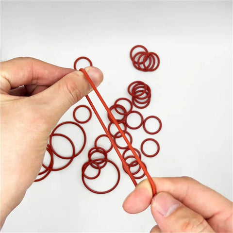 Silicone O Ring Set With CS Size Assortment 1 To 1.5 To 2.0 To 2.4 To 3.1mm Sealing Washers Oil Resistant And High Heat Tolerant Versatile Gasket Kit For Plumbing Automotive Machinery Marine And DIY Projects, red silicone O-rings held by hand