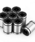 Eight LM10UU 10mm linear bearings with black inner bore, metal casings, front view