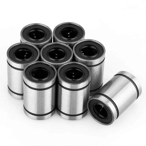 Eight LM10UU 10mm linear bearings with black inner bore, metal casings, front view