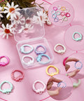 14 Color Spring Gate Ring Set For Keychains And Craft Projects With Strawberry Trigger Snap Buckles on display with daisies