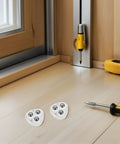 Small Swivel Caster Set With Adhesive Mounting And Triple Ball Bearings on a wooden floor with tools nearby.