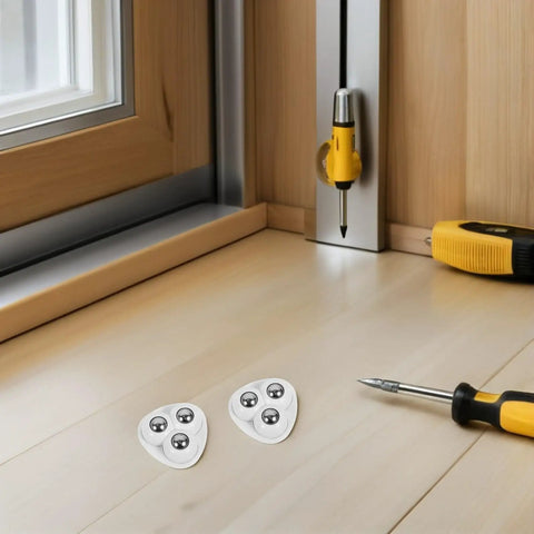 Small Swivel Caster Set With Adhesive Mounting And Triple Ball Bearings on a wooden floor with tools nearby.