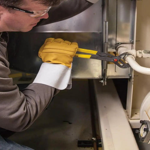 Worker using 10 Inch Quick Adjust Tongue And Groove Pliers With Push Button Ratchet for fast positioning in tight space