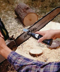 Six Piece Chainsaw Sharpening Attachment Kit For Dremel 1453 Chains in use sharpening a chainsaw blade outdoors