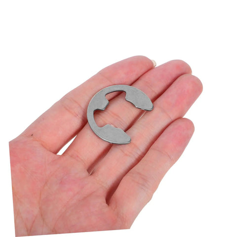 Close-up of a single stainless steel E-type retaining ring for shafts, part of the Stainless Steel External Circlip Assortment Kit E Type Retaining Rings for Shafts Gears and Bearings, Reliable Fastening for Industrial Repair, Heavy Duty Clips and Washers Set for Machinery.