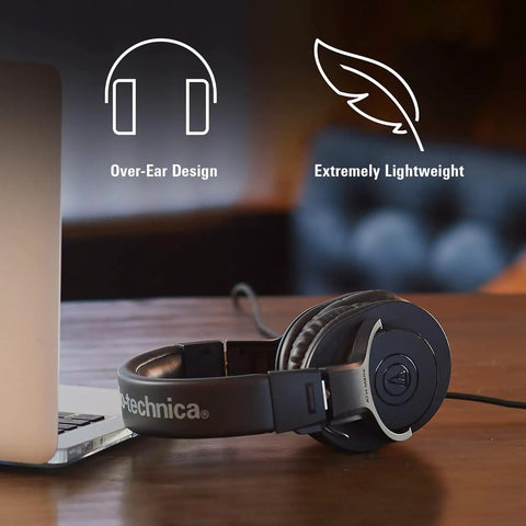 M20x Professional Studio Headphones For Mixing And Monitoring displayed beside a laptop, showcasing lightweight over-ear design.