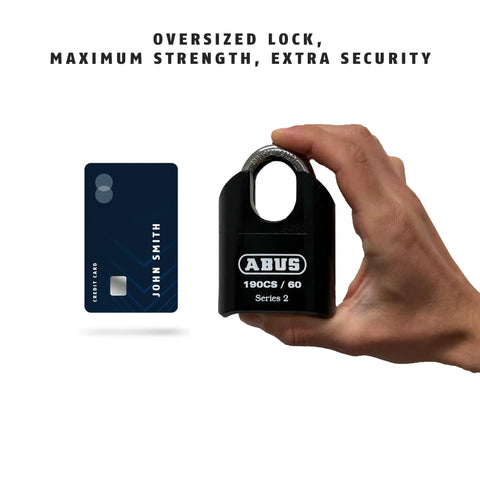 Hand holding 190CS 60 High Security Solid Steel Combination Padlock With 4 Dial Resettable Combination next to a credit card