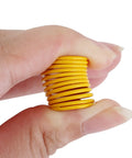 Hand holding yellow alloy spring from Metal Shock Spring Set For One Tenth Scale RC Crawlers Rad Upgrade For TRX4 And Axial SCX10 Platforms.