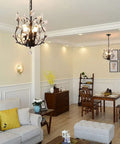 Vintage K9 Clear Crystal 3-Light Pendant Ceiling Fixture In Black Finish hanging in a modern living room with dining area.