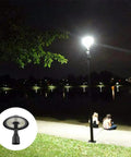 Post Top LED Area Light 150W Outdoor Lamp With 16000 Lumens 500W Equivalent Super Bright Pathway Garden Street Pole Light Fixture Weatherproof Durable Construction For All Climates illuminating a park path at night.