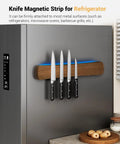 Magnetic Knife Holder For Wall And 16 Inch Acacia Wood Knife Strip mounted on a fridge holding four knives in a kitchen setting