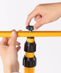 Hands adjusting yellow Adjustable Foldable Metal Tripod Archery Target Stand For Backyard And Shooting Range Bow And Arrow Target Holder