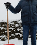 Person holding a shovel with Pro Grade Shovel Replacement Handle Triangle Shape Easy To Install Durable Garden Tool For Quick Grip Upgrade And Long Lasting Performance In Your Yard Or Garden, standing in snowy garden