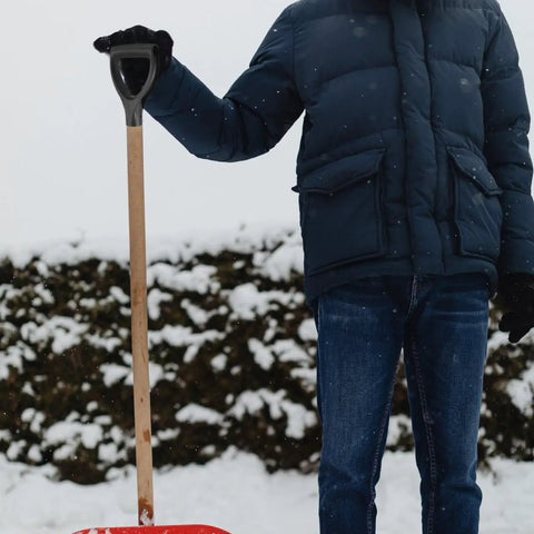 Person holding a shovel with Pro Grade Shovel Replacement Handle Triangle Shape Easy To Install Durable Garden Tool For Quick Grip Upgrade And Long Lasting Performance In Your Yard Or Garden, standing in snowy garden