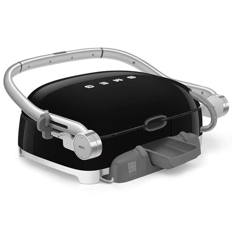 SMEG MGF01 Retro Countertop Electric Grill and Panini Press with swappable plates in black finish, showcasing LCD display and adjustable temperature control.