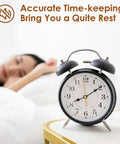Analog clock on table with person sleeping, promotes accurate time-keeping and quiet environment for rest.