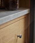 Straight Up Vintage Vibes With These Killer Weathered Nickel Cabinet Knobs Packed In A Six Pack For Instant Counter Makeovers detailed close-up of a weathered nickel cabinet knob on a wooden drawer.
