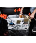 Person organizing tools in 20 Inch Heavy Duty Canvas Tool Tote For Painters Carpenters And Builders With Rugged Zipper and handles