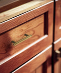 Six Pack 3-Inch Classic Curvature Cabinet Handles In Antique Brass installed on wooden kitchen drawer