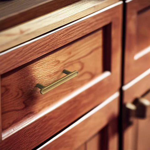 Six Pack 3-Inch Classic Curvature Cabinet Handles In Antique Brass installed on wooden kitchen drawer