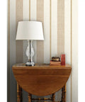 Rich Cream And Modern Gold Vinyl Wallcovering Boasts Subtle Leather Texture For Commercial Grade Heavy Duty Wear backdrop with lamp and decor.