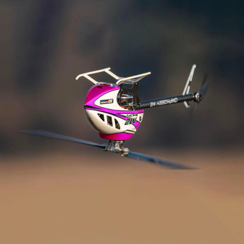 M2 V3 Sport BNF RC Helicopter For Adults With OFS3 Plus Flight Controller in flight, pink body, outdoors