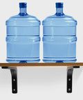 Rock Solid Metal L Floating Shelf Brackets In Matte Black Hold 2 Blue Water Jugs On Wooden Shelf Mounted For Kitchen Use.