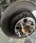 Close-up of 5 Pack M14x1.5 Wheel Studs 57mm Length Tough as Nails Heavy Duty 12.9 Grade Steel Lug Bolts on car hub