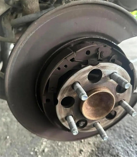 Close-up of 5 Pack M14x1.5 Wheel Studs 57mm Length Tough as Nails Heavy Duty 12.9 Grade Steel Lug Bolts on car hub