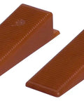 Close-up of two brown wedges from Tile Leveling System Wedges Kit 250-Piece For Fast, Secure Tile Laying With Even Flush Grout Joints.
