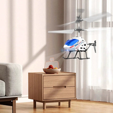 Indoor RC Helicopter For Beginners With Gyro And Altitude Hold in flight near a wooden table and sofa in a living room setting.