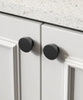18 Pack Black Cabinet Knobs Zinc Alloy Round Drawer Knob 1-5/8 Inch installed on white kitchen cabinet doors