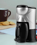 Zero Drama Premium Pink Mini Bean To Cup Coffee Maker Compact Portable Espresso Brewer with black cup and cookies in kitchen.