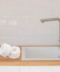 Super Easy White PVC Caulking Tape For Bathtub And Window Gaps Peels Sticks And Seals To Stop Water Leaks Without Messy Tools on kitchen counter.