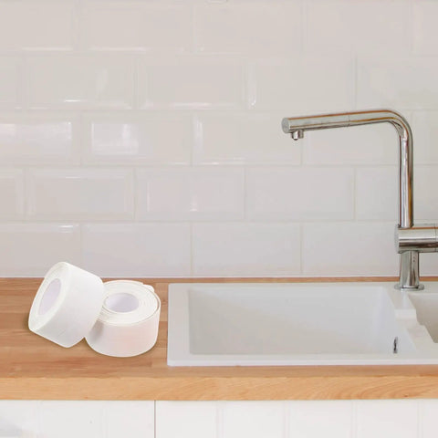 Super Easy White PVC Caulking Tape For Bathtub And Window Gaps Peels Sticks And Seals To Stop Water Leaks Without Messy Tools on kitchen counter.
