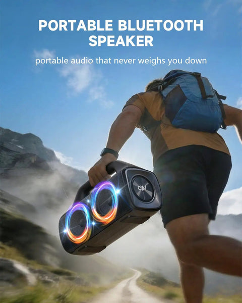 Person hiking with IPX67 Waterproof Bluetooth Speaker With 80W Peak Power Deep Bass And LED Lights, in a mountain landscape.