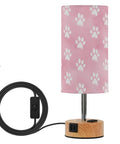 Dope Dog Paw Print Watercolor Bedside Lamp With 3 Way Dimmable Touch Control And Built In Charging Station For Bedroom Nightstand Or Office Desk USB C Port USB A Port And 2 Pin Outlet LED Bulb Included with pink paw print lampshade and wooden base.
