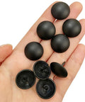 Top Shelf Matte Black Upholstery Tacks 100 Piece Set Heavy Duty Metal Thumb Tacks in hand, showing black round heads and metal prongs.