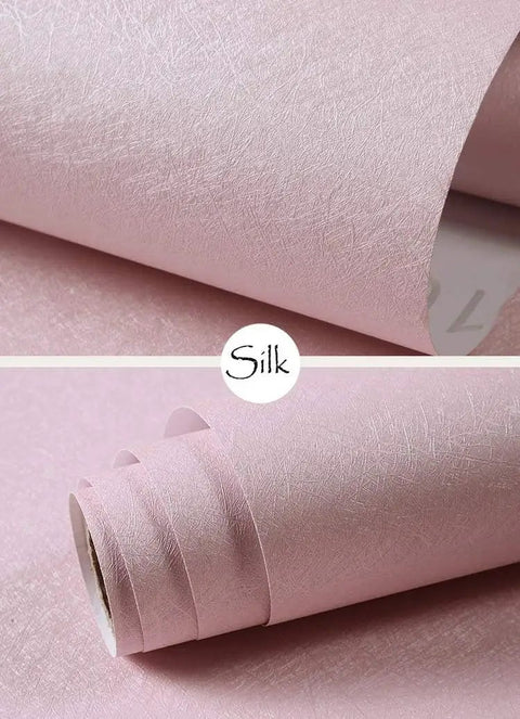 Close-up of pink silk peel and stick wallpaper rolls, textured silk look, waterproof self adhesive, 15.7 inch wide, 197 inch long.